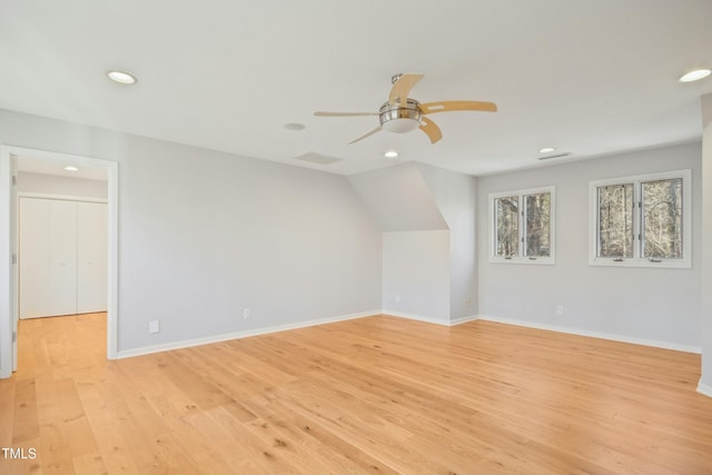 additional living space featuring light wood-type flooring, ceiling fan, and vaulted ceiling