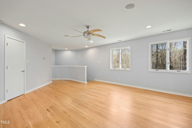 spare room featuring ceiling fan and light hardwood / wood-style flooring