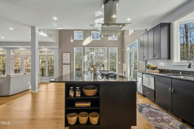 kitchen with sink, french doors, dark stone countertops, and a kitchen island