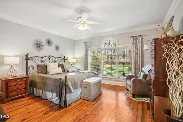 bedroom with wood-type flooring, ornamental molding, and ceiling fan