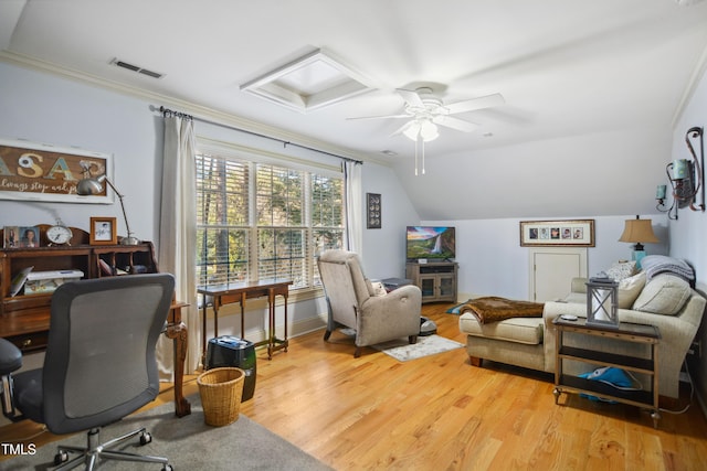 office space featuring lofted ceiling, ornamental molding, wood finished floors, and visible vents