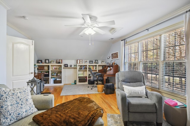 living room featuring ceiling fan, vaulted ceiling, ornamental molding, and wood finished floors