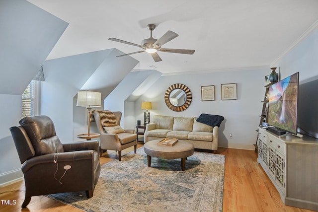 living room featuring crown molding, light wood finished floors, lofted ceiling, a ceiling fan, and baseboards