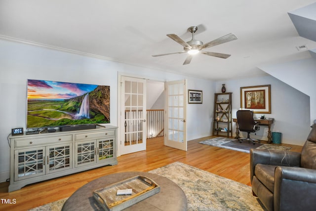 living room with french doors, wood finished floors, visible vents, and crown molding