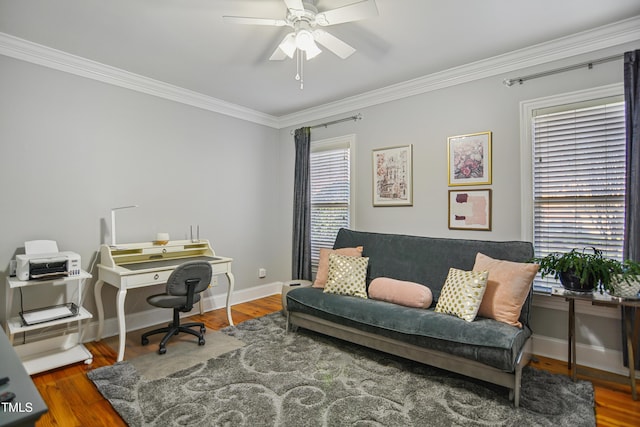 office area featuring a ceiling fan, crown molding, baseboards, and wood finished floors