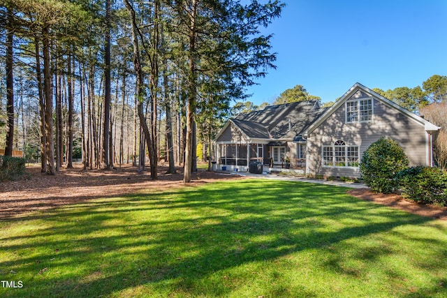 back of property featuring a lawn and a sunroom