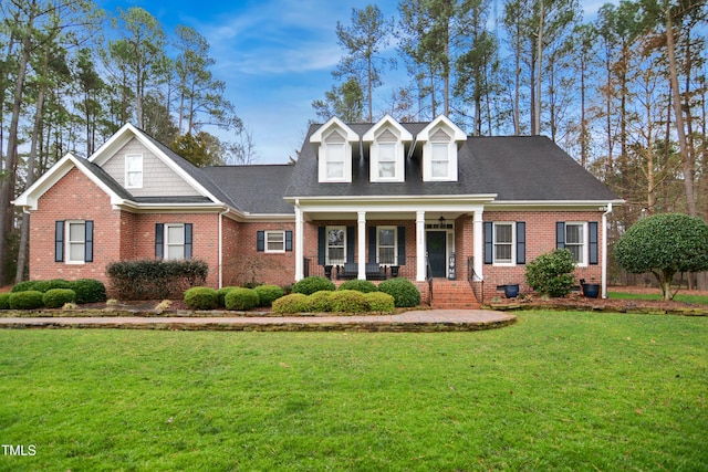 new england style home with crawl space, brick siding, and a front yard