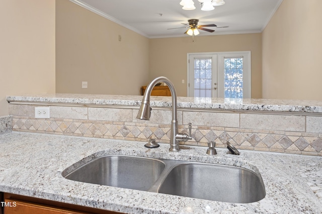 kitchen featuring light stone countertops and sink