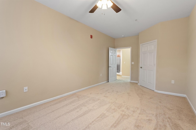 unfurnished room with ceiling fan and light colored carpet