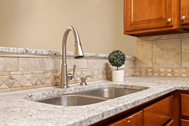 interior details with light stone countertops and sink