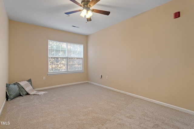 empty room featuring carpet flooring and ceiling fan