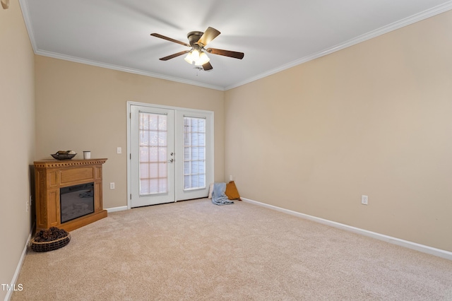 interior space featuring crown molding, french doors, ceiling fan, and light carpet