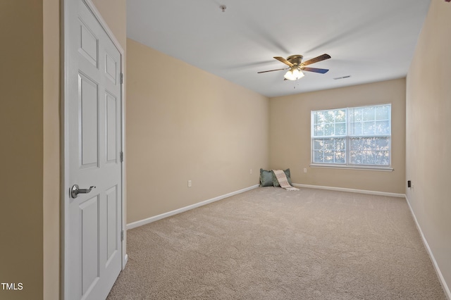 carpeted empty room featuring ceiling fan