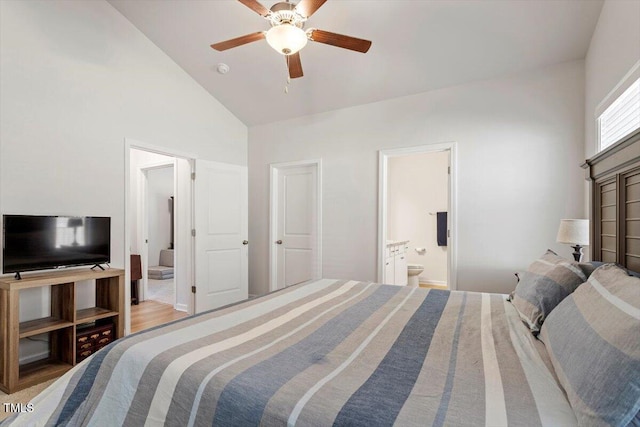 bedroom with high vaulted ceiling, ceiling fan, ensuite bath, and wood finished floors