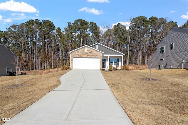 ranch-style home with stone siding, a front yard, concrete driveway, and a garage