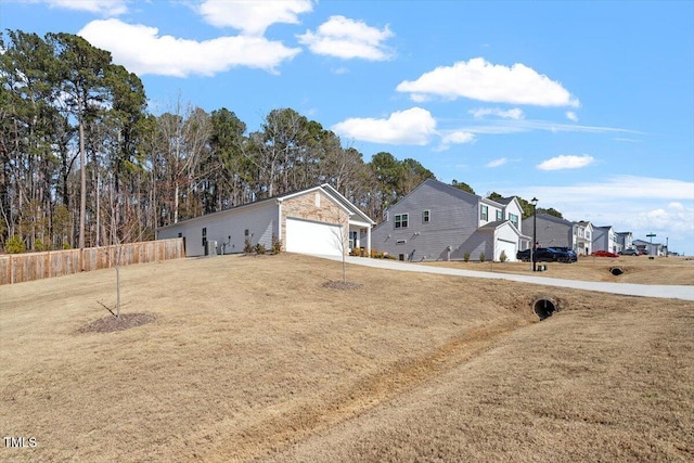 view of yard with a garage and fence