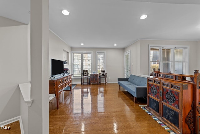 living room with crown molding and hardwood / wood-style floors