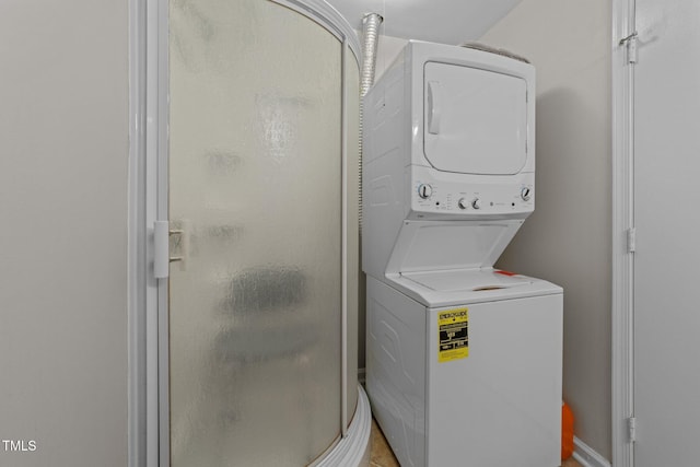 washroom featuring stacked washer / dryer