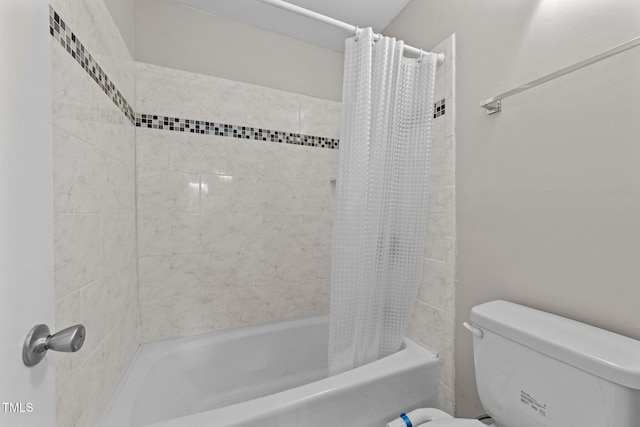 bathroom featuring shower / bath combo with shower curtain and toilet