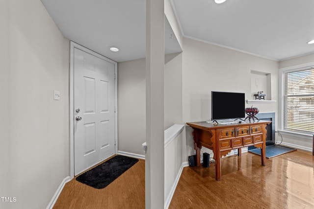 interior space with crown molding and wood-type flooring