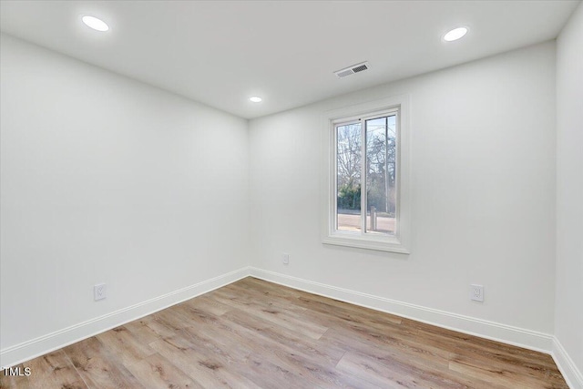 spare room featuring light hardwood / wood-style floors