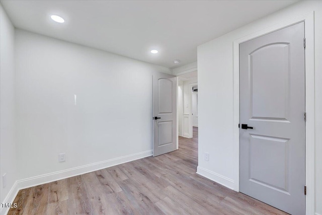 spare room with light hardwood / wood-style floors