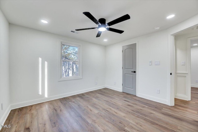 unfurnished room with light wood-type flooring and ceiling fan