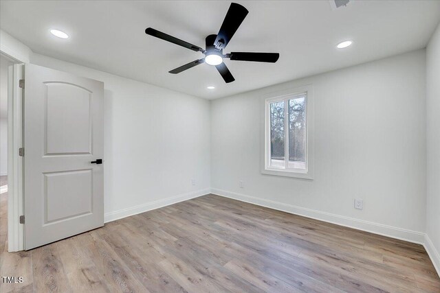 spare room with ceiling fan and light hardwood / wood-style flooring