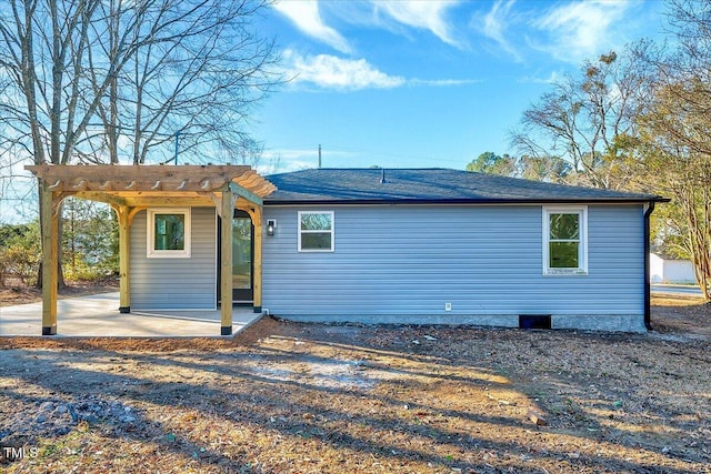 back of house with a pergola and a patio area