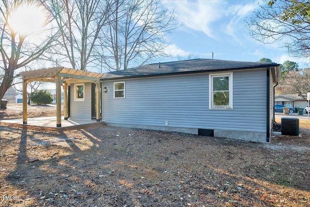 back of house featuring central AC unit, a pergola, and a patio area