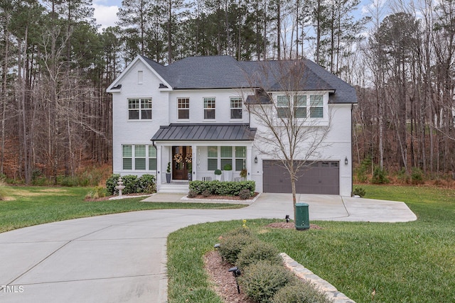 view of front of house featuring a front yard and a garage