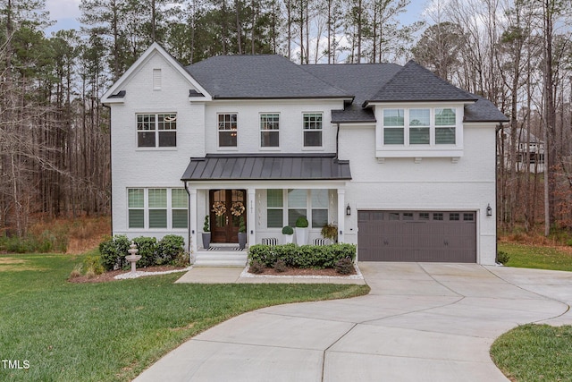 view of front of property with a garage and a front lawn