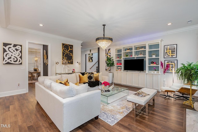 living room featuring dark hardwood / wood-style flooring, an inviting chandelier, and ornamental molding