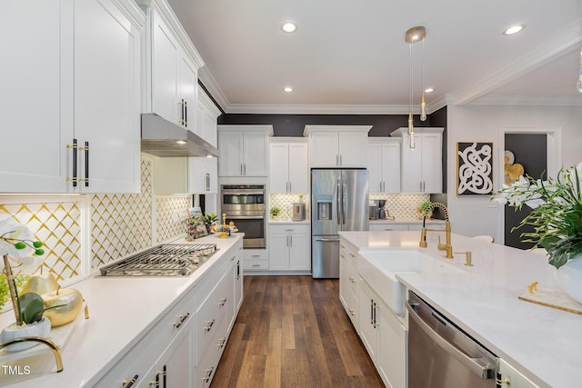 kitchen featuring appliances with stainless steel finishes, white cabinetry, tasteful backsplash, sink, and crown molding