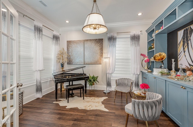 sitting room with dark hardwood / wood-style floors and crown molding