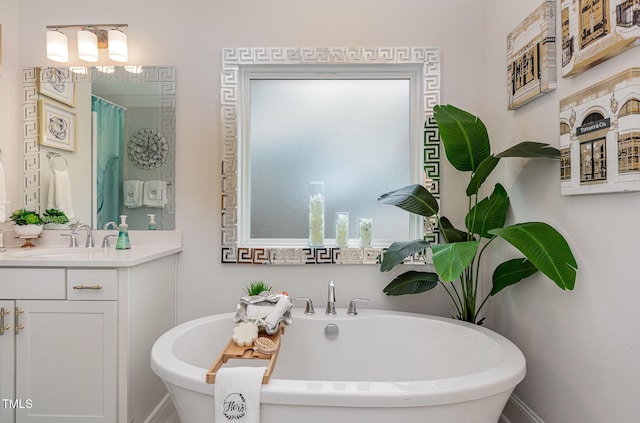 bathroom featuring a washtub and vanity