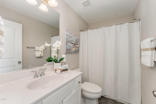 bathroom featuring vanity, tile patterned flooring, and toilet