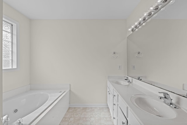 bathroom featuring a tub to relax in, a healthy amount of sunlight, and vanity