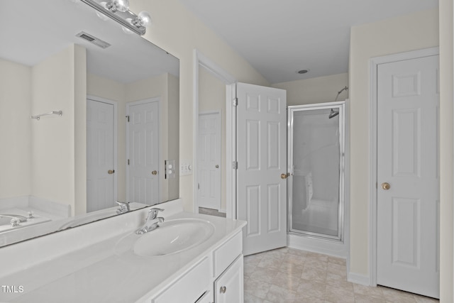 bathroom featuring vanity, tile patterned floors, and walk in shower