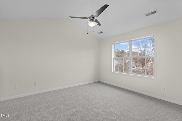 unfurnished room with vaulted ceiling, ceiling fan, and carpet flooring