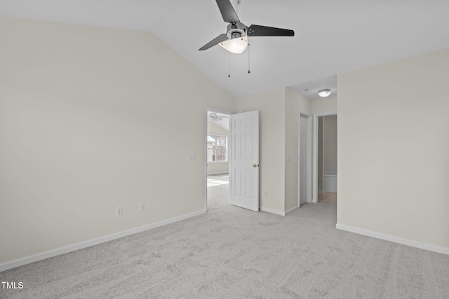 carpeted empty room with vaulted ceiling and ceiling fan