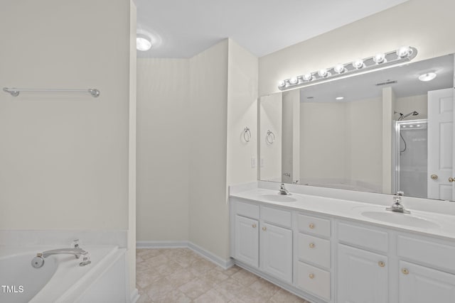 bathroom with vanity and shower with separate bathtub