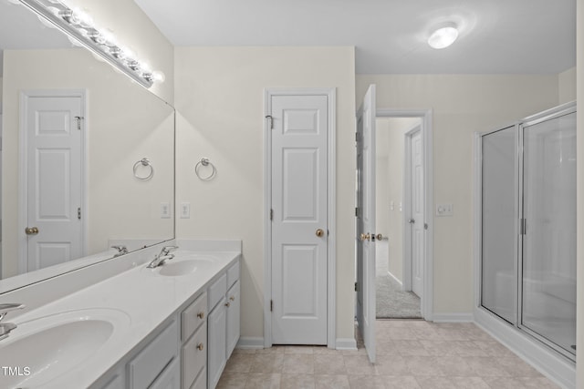 bathroom with vanity and a shower with door