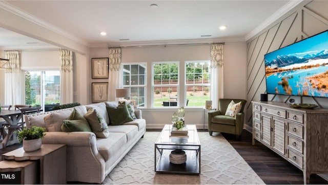 living room featuring wood-type flooring, plenty of natural light, and ornamental molding