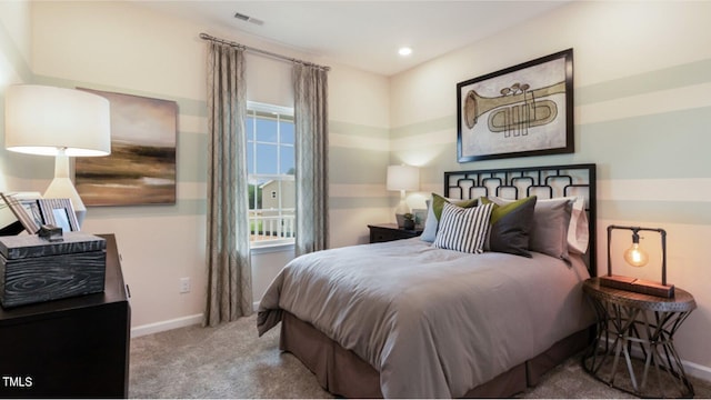 bedroom featuring multiple windows and light carpet