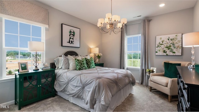 carpeted bedroom featuring a notable chandelier