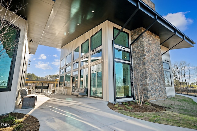 view of exterior entry featuring a patio and an outdoor bar