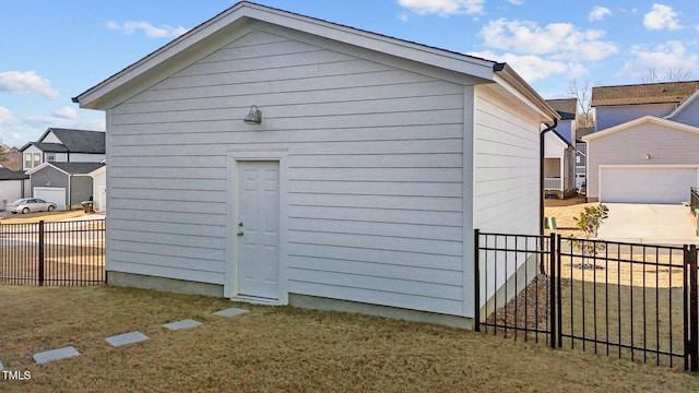 view of outdoor structure with a garage and a lawn