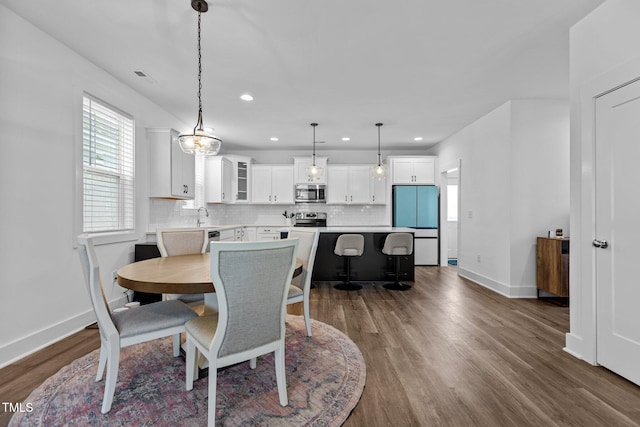 dining space featuring sink and dark hardwood / wood-style flooring