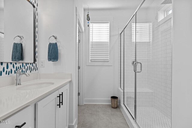 bathroom featuring walk in shower, tile patterned floors, and vanity